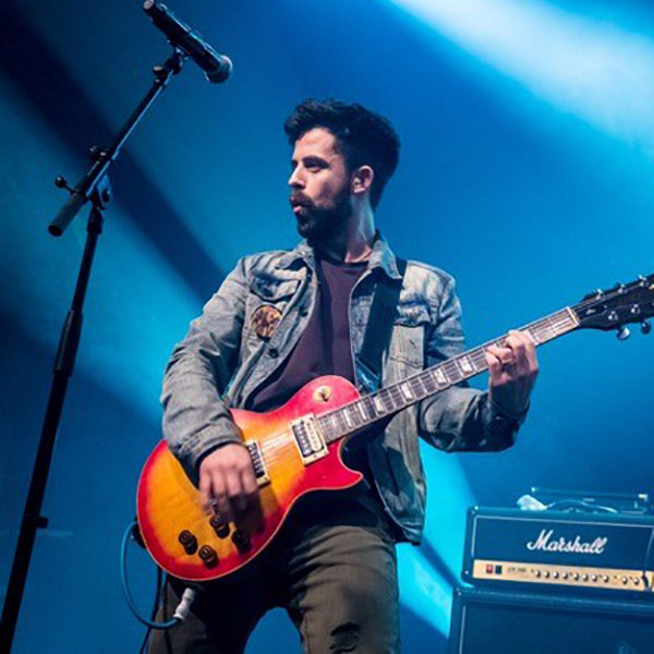 Robby Miller stage performing with guitar